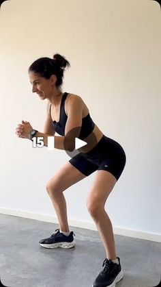 a woman in black shirt and shorts doing squat exercises