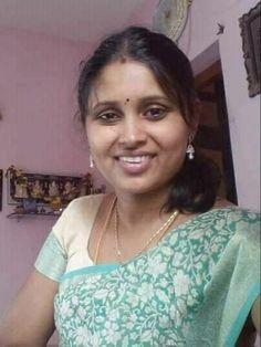 a woman wearing a green and white sari