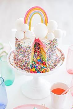 a cake with sprinkles and rainbow decorations