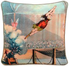 an image of a woman flying through the air on top of a pillow with people watching