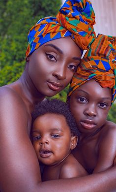 two women and a child are posing for the camera with their heads wrapped around each other