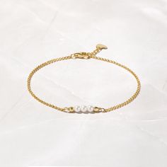 A graceful, timeless bracelet with three exquisite pearls! Stack this piece with other bracelets, or wear it alone for a minimalist, yet sophisticated style. The perfect bridesmaids gift too! 14K Gold Plated over Sterling Silver Nickel-free & hypoallergenic Made of highest quality imitation pearls for an authentic look Pearl size: 3.5mm Lobster clasp closure with 0.5" extension