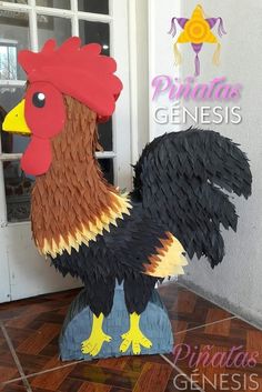 a paper mache rooster is standing in front of a door with the words prima genius on it