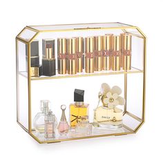 a display case with lipstick, perfumes and other items in it on a white background