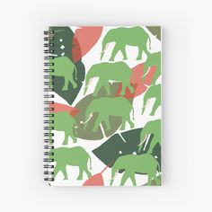 a spiral notebook with elephants and leaves on the cover, all in shades of green