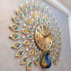 a clock that is on the side of a wall with a peacock face and feathers