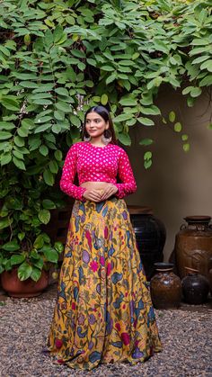 Mustard Yellow soft silk printed lehenga set comes with closed neck bandhani blouse in pink color which features full sleeves and closed back with hook-eye opening. Color of Lehenga - Mustard Yellow. Color of Crop Top - Pink. Fabric of Lehenga- Printed Soft Silk. Fabric of Crop Top - Modal Silk. Number of components - 2. Measurements in the size chart are all garment measurements. The actual print-placement of the product may vary slightly from the image shown. Standard Lehenga Length - 43". Sta Semi-stitched Long Sleeve Anarkali With Kalamkari Print, Traditional Long Sleeve Anarkali Set With Kalamkari Print, Wedding Traditional Wear With Block Print And Long Sleeves, Multicolor Long Sleeve Anarkali Set With Kalamkari Print, Long Sleeve Block Print Sharara For Navratri, Pink Bollywood Traditional Wear With Block Print, Pink Bandhani Print Art Silk Choli, Pink Block Print Traditional Wear For Navratri, Pink Traditional Wear With Block Print For Navratri