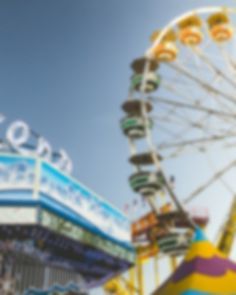 an amusement park with ferris wheel and carnival rides