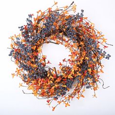 an orange and blue wreath is hanging on the wall