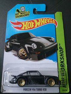 a hot wheels black car with gold rims