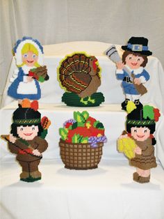 a table topped with lots of little figurines on top of a white cloth