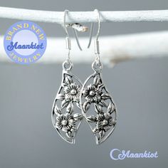 These Sterling Silver Dainty Blossom Earrings feature lovely Art Nouveau inspired designs. These dangle earrings measure 44.5 mm (approx. 1.75 inches) in total length. The dangle measures 25 mm (approx. 1 inch) in overall length. The width of these earrings are 13 mm (approx. .5 inches). These earrings are great for everyday wear, or as a gift for your special someone! Art Nouveau is an international style of art that was most popular between 1890 and 1910. A reaction to the geometric art of the Summer Flower Sterling Silver Earrings For Gift, Sterling Silver Flower Earrings For Summer, Summer Flower Earrings In Sterling Silver For Gift, Sterling Silver Flower Earrings For Summer Gift, Silver Flower Earrings For Summer, Silver Flower Charm Earrings For Summer, Silver Earrings With Flower Charm For Summer, Summer Silver Earrings With Flower Charm, Handmade Silver Flower Earrings For Mother's Day