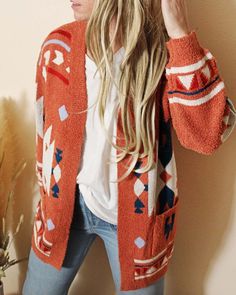 The softest knit base pairs with an Aztec print, open cardigan front & an easy long fit. Oversized long fit with an open front & soft cozy teddy knit. Color: Desert clay, red & teal Acrylic/poly blend Hand wash cold Model is a size 8 wearing a medium. Small Medium Large Bust 41 43 45 Waist 42 44 46 Hips 44 46 48 Length 31 31 31 Bust, waist, and hip measurements are a total circumference. Length is measured from the top of the shirt to the hem. Measurements are an estimate. Winter Printed Sweater, Casual Jacquard Knit Sweater For Loungewear, Open Front Printed Cardigan For Fall, Cozy Jacquard Knit Cardigan For Fall, Casual Open Front Printed Cardigan, Red Jacquard Knit Outerwear For Fall, Oversized Printed Winter Outerwear, Cozy Jacquard Knit Cardigan, Aztec Sweater Baha Ranch Western Wear