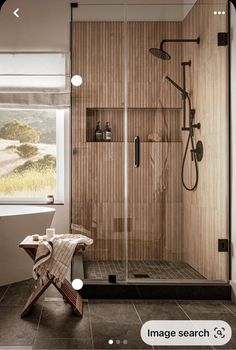 a bathroom with a walk in shower next to a window