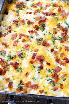 a casserole with bacon and cheese in a pan on top of a wooden table