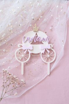 a cake topper with a princess carriage on it's head and the word cannon above it