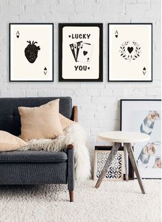 three framed pictures hang on the wall above a couch in a room with white carpet