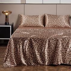 a leopard print bed spread with matching pillows