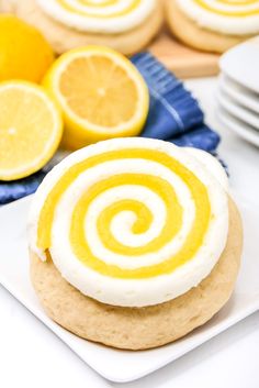 a close up of a cookie on a plate with some lemons in the background