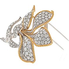 Relish in the confluence of style and substance with the Platinum & 18K Yellow Gold 25.00 carat total weight Diamond Flower Brooch, a testament to timeless elegance and exquisite craftsmanship. This magnificent brooch exudes luxury and sophistication, making it a coveted addition to any fine jewelry collection.At the heart of this masterpiece is a breathtaking 25.00 carat total weight of round diamonds, showcasing F-G color and VS-SI clarity that dazzle with every movement. The intricate design of the flower motif is a symbol of natural beauty and grace, meticulously crafted in platinum and 18K yellow gold for a harmonious blend of precious metals.Whether adorning an evening gown or adding a touch of glamour to everyday attire, this brooch is a versatile statement piece that captures atten Diamond Flower Brooch, Gold Beauty, Diamond Birthstone, Flower Motif, Diamond Flower, Fine Jewelry Collection, Intricate Design, Flower Brooch, Relish