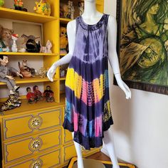 Tag: Colorz  Vintage 80's hippie girl dress in 100% gauzy rayon. Sheer and super lightweight so it's great for a beach coverup or layering dress. Tie dye in rainbow colors with embroidered details along hem, neckline and arms! Slips on over head so it has no buttons or zips. I think it'll fit up to XL but please check below for max fit.                          Bust 50''  Waist 60''  Hips 60''  Length 43''  Shoulder to Shoulder open  Sleeves n/a  Excellent condition with no flaws to note. Flowy Multicolor Tunic Cover-up, Multicolor Casual Tunic Beach Dress, Casual Multicolor Tunic Beach Dress, Flowy Hippie Summer Cover-up, Multicolor Rayon Sundress For Vacation, Flowy Hippie Beach Cover-up Dress, Flowy Rayon Hippie Dress, Flowy Multicolor Rayon Maxi Dress, Hippie Style Flowy Tunic Dress