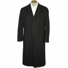 This is a luxurious pre-owned 100% cashmere black overcoat made of Italian fabric.  The fabric is very soft, in a medium thickness and of very nice quality.  The coat was made in Montreal, Canada by Empire, a manufacturer with a history dating to 1917 and known for its quality.  The coat is made in an easy to wear classic style with higher set medium width notched lapels, three button closure hidden by an overflap, relaxed shoulders, diagonal side pockets, three button cuffs and 18 1/2” kick ple Black Long Coat For Semi-formal Occasions, Classic Long Coat With Concealed Placket, Classic Long Pea Coat For Business, Formal Long Sport Coat In Solid Color, Solid Long Sport Coat For Formal Occasions, Classic Outerwear With Lapel Collar For Business, Classic Long Coat With Hidden Button Closure, Classic Tailored Outerwear For Cold Weather, Tailored Classic Outerwear For Cold Weather