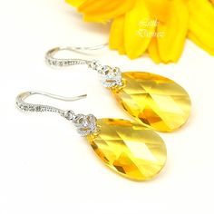 Yellow Earrings, Bridal Yellow Earrings, Yellow Drop Crystal Earrings, Sunflower Lemon Zest Dangle Earrings, Bridesmaids Earrings, LT32H Introducing our vibrant Yellow Crystal Earrings designed to add a pop of color and modern elegance to any ensemble! 💛✨ ✨ Genuine Crystals: Adorned with stunning 22mm Swarovski Light Topaz/Yellow pear-shaped pendant crystals, these earrings exude brilliance and sophistication.  👂 Hypoallergenic Design: Crafted with hypoallergenic Rhodium plated rhinestone ear Yellow Bridesmaid, Yellow Sunshine, Topaz Yellow, Pear Shaped Pendant, Yellow Bridesmaids, Yellow Jewelry, Sunflower Earrings, Sparkly Jewelry, Crystal Dangle Earrings