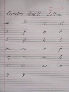 a handwritten cursive alphabet is shown on a piece of paper