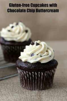 two chocolate cupcakes with white frosting on top