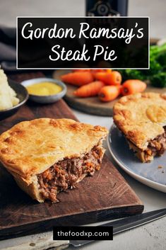 a steak pie on a cutting board with carrots and mashed potatoes in the background