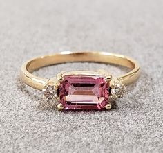 1. Pink Tourmaline with Diamond 14k Gold Ring 2. Ready to ship 3. Gemstone - Pink Tourmaline, Diamond  4. Jewelry Type - Gold Ring 5. Total Weight - 2.040 Gram Approx. 6. Diamond Weight - 0.06 Carats  7. Tourmaline Weight - 0.80 Carats 8. Gold Weight - 1.868 Grams Approx.  9. Tourmaline Size - 5 x 7 MM 10. Gold Purity - 14k 11. Band Size - 2 MM 12. Handmade Items 13. AAA Quality Ring 14. Stackable Ring 15. 1 Quantity Available 16. Ready to Dispatch in 1 - 2 days. 17. Baguette Pink Tourmaline   P Classic Tourmaline Rings For Anniversary, Fine Jewelry Tourmaline Diamond Ring For Anniversary, Emerald Cut Tourmaline Ring For Anniversary, Tourmaline Ring With Prong Setting For Anniversary, Anniversary Rings With Pink Sapphire And Gemstone Accents, Tourmaline Rings With Gemstone Accents For Anniversary, Anniversary Pink Sapphire Rings With Gemstone Accents, Anniversary Rings With Tourmaline Gemstone Accents, Tourmaline Rings With Prong Setting For Anniversary