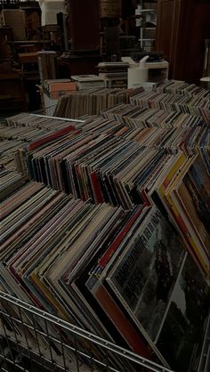 a shopping cart filled with lots of record records in a room full of other records