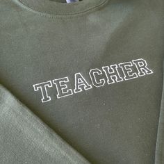 Embroidered Teacher Sweatshirt, Teacher Sweatshirt, Gift for Teacher, Teacher Gift, Christmas Gift for Teacher We offer a variety of custom made embroidery apparel.   See photos above for size and color options.   Our crewneck sweatshirts and hoodies come in  size S - 2 XL. Please choose from the dropdown menu what size and color you'd like.  In the notes at checkout, please let me know the thread colors you'd like on your clothing, otherwise, it will be made like the photo.  Visit the rest of o College Winter T-shirt With Embroidered Text, Winter College T-shirt With Embroidered Text, Embroidery Apparel, Teacher Gift Christmas, Christmas Gift For Teacher, Teachers Diy, Teacher Teacher, Embroidery On Clothes