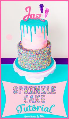 a cake with sprinkles on it sitting on top of a pink and blue table