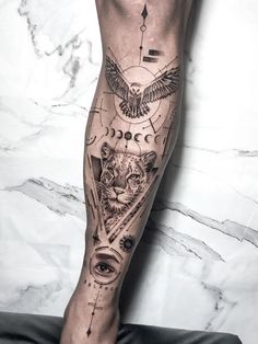 a man's leg with tattoos on it and an owl in the center, surrounded by other symbols