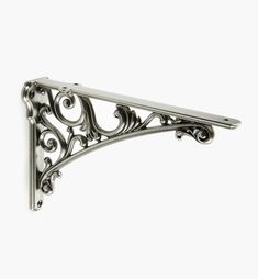 an ornate metal shelf bracket on a white background