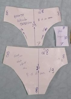 two pieces of paper cut out to look like bikinis with numbers on them and one piece missing