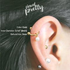 an ear piercing is shown with pearls on it