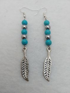 Meet Erica, ER082, a Pretty Pair of Earrings with Turquoise and Silver Beads and Silver Feather Charms. Makes a Thoughtful Gift or Even Something Special for Yourself! 2.5 inches long. Feather Charm Earrings, Pumpkins Crafts, Turquoise Feather Earrings, Diy Pumpkins, Acrylic Nails Almond Shape, Granite City, Earrings Feather, Almond Shape, Nails Almond