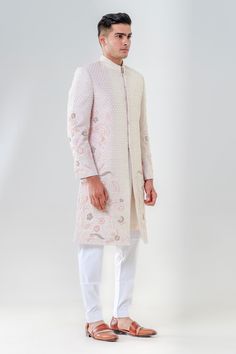 Salmon pink sherwani featuring delicately embroidered cut dana floral motifs highlighted by threadwork. Comes with a kurta and pant.
Components: 3
Pattern: Embroidered
Type Of Work: Cut dana, Threadwork
Neckline: Mandarin Collar
Sleeve Type: Full
Fabric: Raw Silk
Color: Pink
Other Details: 
Hook button closure
Welt pocket
French knot embroidered motifs
Occasion: Groom,Wedding - Aza Fashions Pink Sherwani, Embroidered Sherwani, Embroidered Motifs, French Knot, Salmon Pink, Floral Motifs, Wedding Groom, Embroidered Silk, Raw Silk