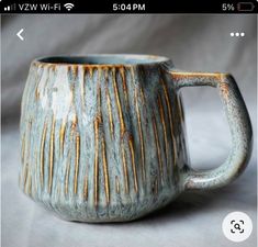 a ceramic mug with brown and white stripes on the inside is shown in an instagram