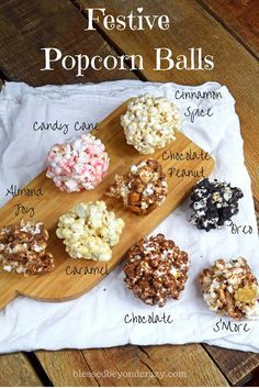 a wooden board topped with different types of popcorn balls