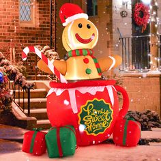 an inflatable christmas decoration with a gingerbread man sitting on top of it