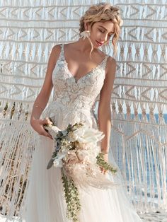 a woman in a wedding dress holding a bouquet