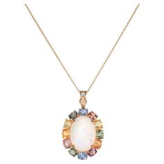 Glamorous Gemstones - Sunita Nahata started off her career as a gemstone trader, and this particular collection reflects her love for multi-colored semi-precious gemstones. The pieces in this collection are exclusively curated by Sunita to present unique items that incorporate fancy and exclusive gemstones cuts and color combinations. 6.17 Carat Opal Pendant in 18 Karat Yellow Gold with Multi Sapphire and White Diamond. Opal: 6.17 carat, 18X13mm size, Cabochon cut, Oval Shape. Multi Sapphire: 5.40 carat, 5X4mm size, Oval Shape. White Diamond: 0.038 carat, 2.00mm size, Round Shape, G Colour, VS clarity. Gold: 4.83g, 18K Yellow gold. P182 Multi Sapphire, Naha, Opal Pendants, Precious Gemstones, Cut And Color, Semi Precious Gemstones, White Diamond, Oval Shape, Semi Precious