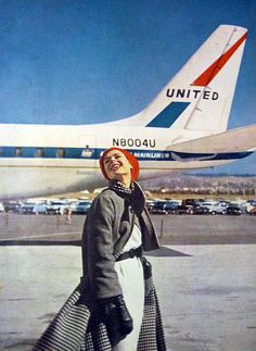 a woman is standing in front of an airplane