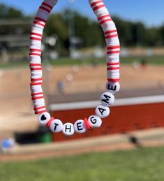 A baseball themed clay bead bracelet. White and red. Baseball Bead Bracelet, Red Team Spirit Bracelets For Gifts, Red Letter Beads Bracelets For Everyday, Red Letter Beads Bracelet For Everyday, Red Everyday Bracelets With Letter Beads, Everyday Red Bracelets With Letter Beads, Personalized Red Bracelets For Team Spirit, Red Personalized Bracelets For Team Spirit, Red Team Spirit Bracelets For Sports Events