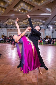 two people are dancing on the dance floor