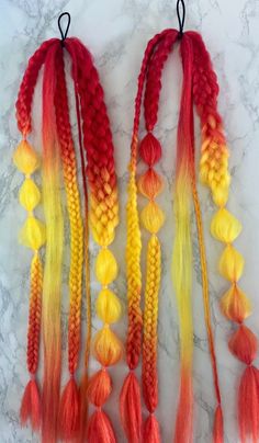 Light a fire as you strut your sultry locks. Reds, Oranges, and Yellows for a firey look. 5 Strand Braids, 7 (Yes, 7!) Strand Braids, Bubble Braids, and Fishtail Braids...just in case you couldn't decide which styles you liked the best, we got you covered with this big variety 😉😉On a hair tie for easy use. Wrap the loose hair section around a ponytail or bun and secure with a bobby-pin, or braid it into your own hair for awesome and easy festival braids. Sold as a set of 2 pigtails. Natural Curly Hair Blonde, Curly Hair Blonde Balayage, Fire Wig, Yellow Hair Color Ideas, 2 Pigtails, 5 Strand Braids, Braids Extensions, French Fishtail, Fishtail French Braid