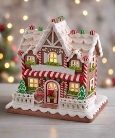 a gingerbread house is decorated with candy canes